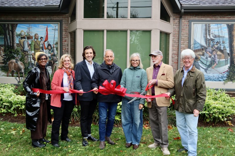 The ribbon was cut on the new Lewes History Museum mural Oct. 14. The artwork by Michael Rosato depicts the city’s maritime history, starting with Indigenous people and continuing to the city’s shipbuilding industry. Shown are (l-r) Trina Brown-Hicks, Lewes city councilwoman; Amy Marasco, Lewes mayor; Andrew Lyter, Historic Lewes executive director; Michael Rosato, artist; Heidi Lowe, Lewes Public Art Committee chair; Tony Boyd-Heron, Art in Bloom project manager; and Tim Ritzert, Lewes city councilman. BILL SHULL PHOTO
